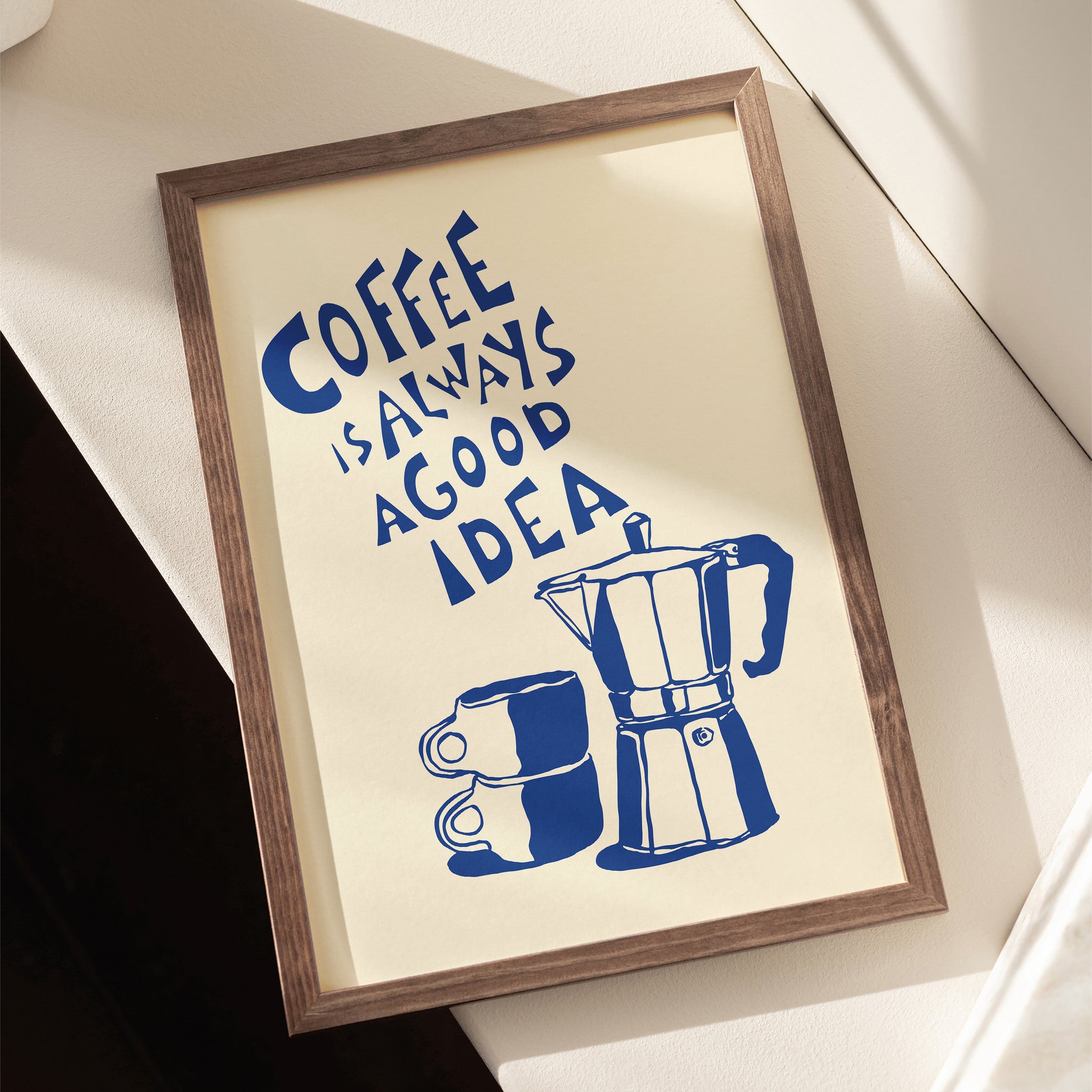Wall art poster featuring a moka pot and coffee cups with "Coffee is always a good idea" in playful typography